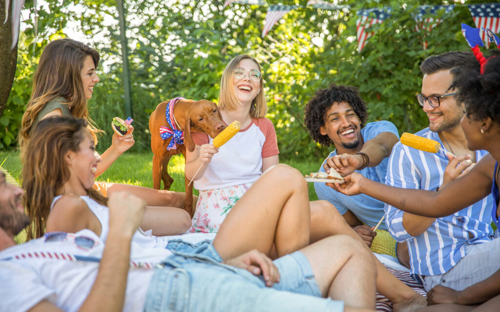 adults in the backyard having a picnic