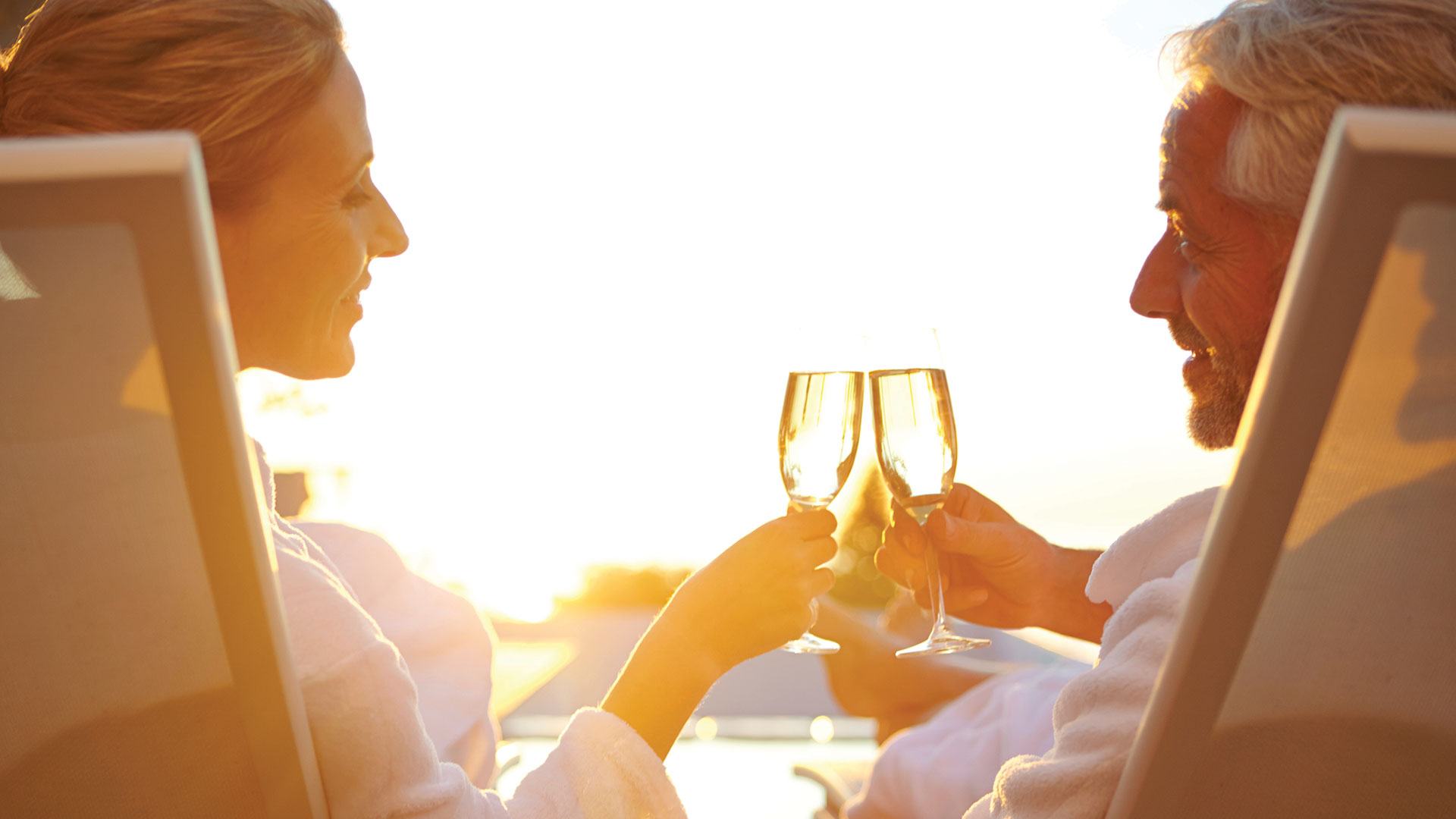 N Pic Active Adult Couple Outdoors Cheers Chairs Sunset